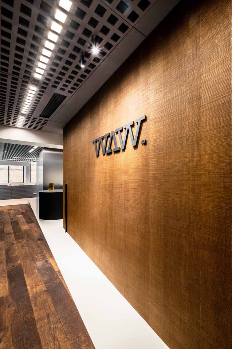 Entrance with veneer wall and grid ceiling made of Unilin Panels decorative MDF.